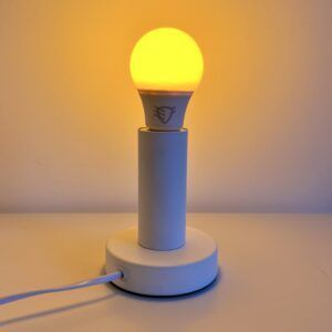 Biała lampka z zapaloną żarówką DayTorch